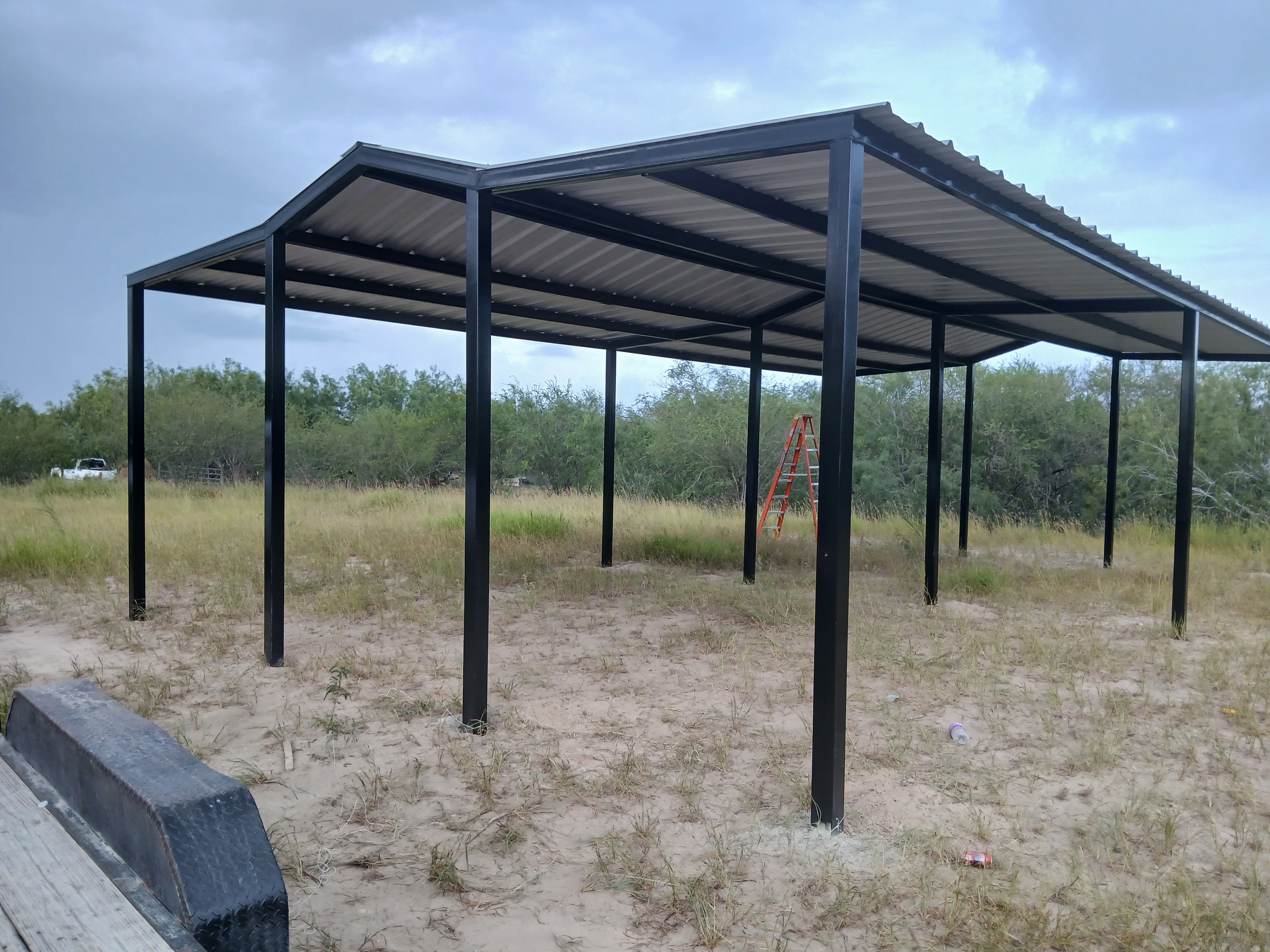 Freestanding metal carport with a gable roof on the Mesquite Sheds & More lot in Alamo, TX